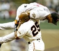 Barry Bonds picks up Torii Hunter after Torii robbed him of a first inning homerun.
